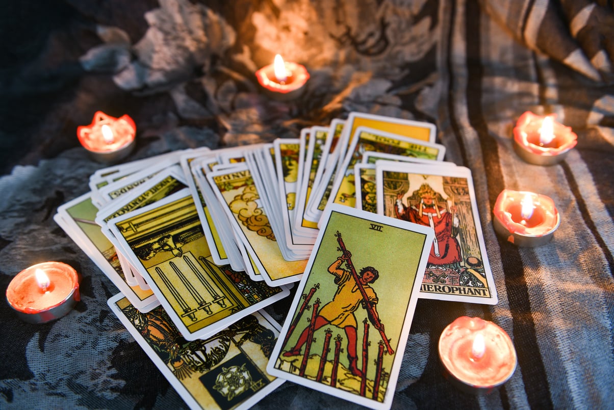 Tarot Cards with Candlelights on a Dark Fabric